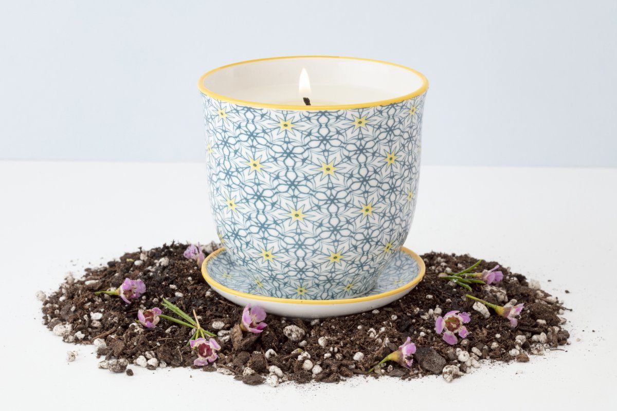 This yellow star Liberte pot is poured in a coconut soy blend wax by women artisans in the United States. Once the wax is gone, the vessel turns into a place to plant beautiful plants and flowers.