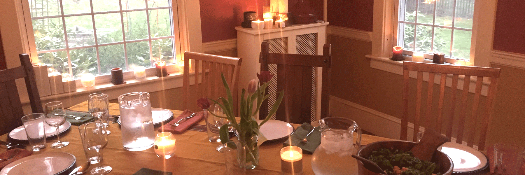 Fair trade candles lit in dining room handmade by Propserity Candle's women artisans